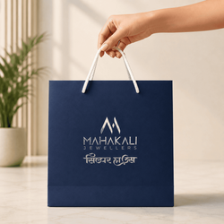 Mahakali_Jewellers_custom_paper_bag_held_by_hand_for_jewellery_packaging_1783329907519.png