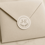 Custom envelope seal sticker with J&E monogram on beige wedding envelope