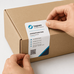 Hand applying custom visiting card sticker on envelope packaging