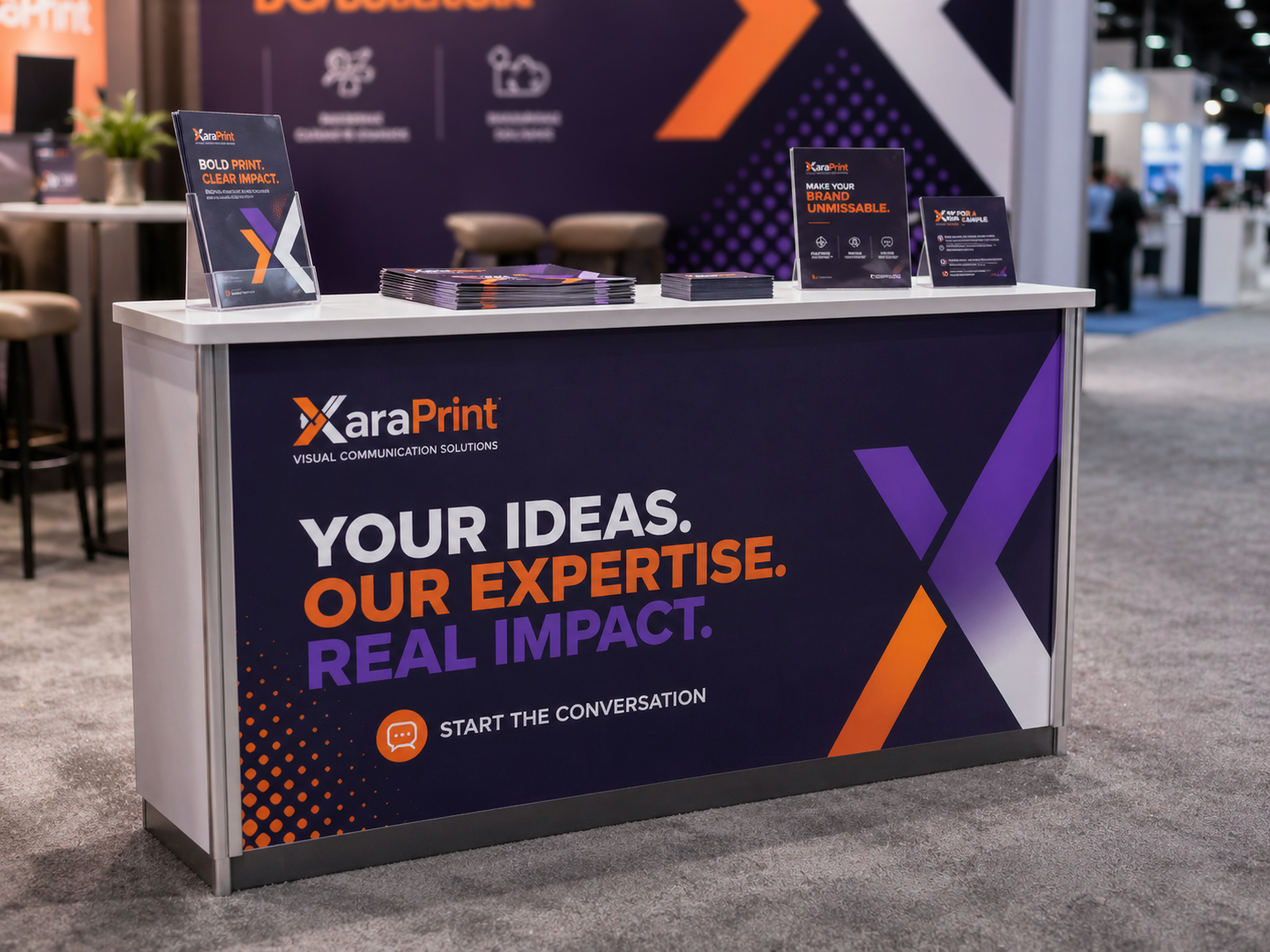Branded event counter with clean logo and printed booth graphics